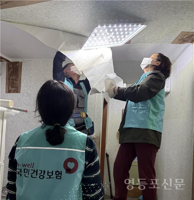 하늘반창고 집수리봉사단이 도배 작업을 하고 있다.